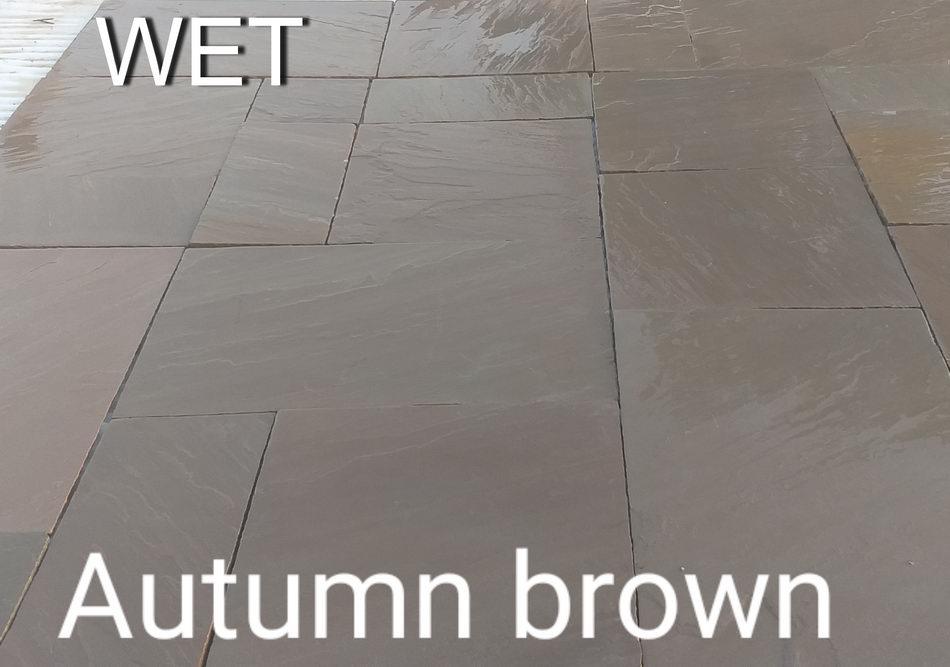 autumn brown sandstone paving slabs wet